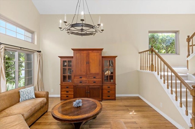 4635 Allende Ave, Oceanside, CA 92057 - living area featuring a chandelier, light wood-style floors, a high ceiling, and stairway