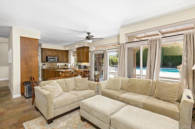 4635 Allende Ave, Oceanside, CA 92057 - living room with stone finish floors and a ceiling fan
