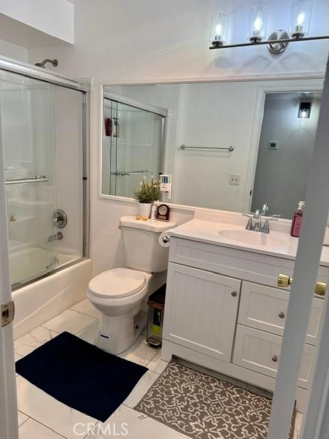 5700 Etiwanda Ave Unit 105, Tarzana, CA 91356 - full bathroom featuring vanity, bath / shower combo with glass door, and tile patterned floors