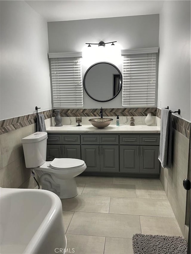 10430 San Jose Ave, South Gate, CA 90280 - full bath featuring a tub to relax in, tile walls, vanity, and tile patterned flooring