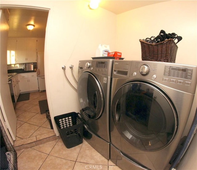 2904 Sterling St, Pomona, CA 91767 - washroom with washer and clothes dryer and light tile patterned floors