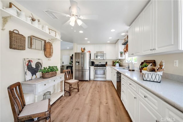 40633 Corte Albara, Murrieta, CA 92562 - kitchen featuring stainless steel appliances, a ceiling fan, light countertops, light wood finished floors, and white cabinets