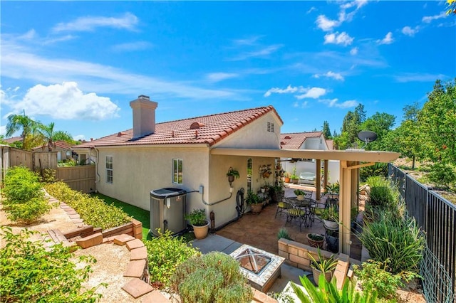 40633 Corte Albara, Murrieta, CA 92562 - rear view of house featuring a tiled roof, a chimney, a patio area, and a fenced backyard