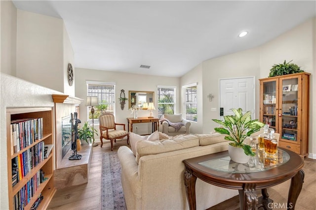 40633 Corte Albara, Murrieta, CA 92562 - living room featuring light wood-type flooring, lofted ceiling, recessed lighting, and a high end fireplace