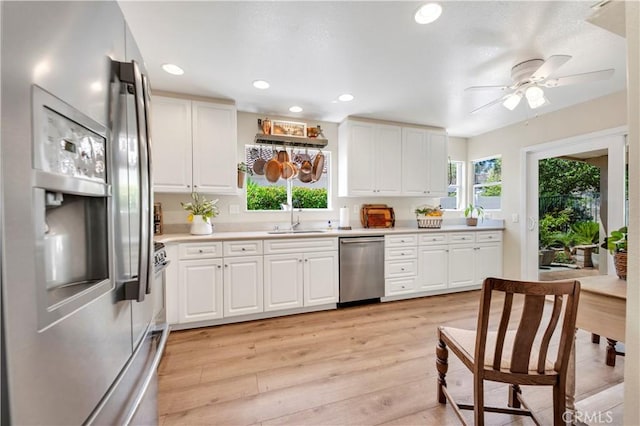 40633 Corte Albara, Murrieta, CA 92562 - kitchen with appliances with stainless steel finishes, healthy amount of natural light, light countertops, light wood-type flooring, and recessed lighting
