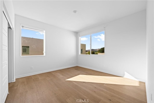 536 Cultivate, Irvine, CA 92618 - unfurnished bedroom featuring wood finished floors and multiple windows