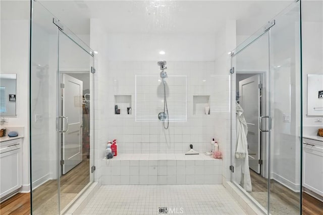 3969 Eliopulos Ranch Dr, Palmdale, CA 93551 - full bath with vanity, a stall shower, and wood finished floors
