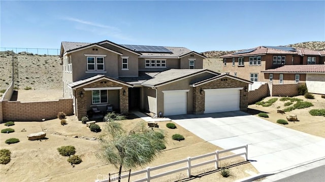 3969 Eliopulos Ranch Dr, Palmdale, CA 93551 - traditional home featuring stucco siding, solar panels, driveway, a tiled roof, and an attached garage