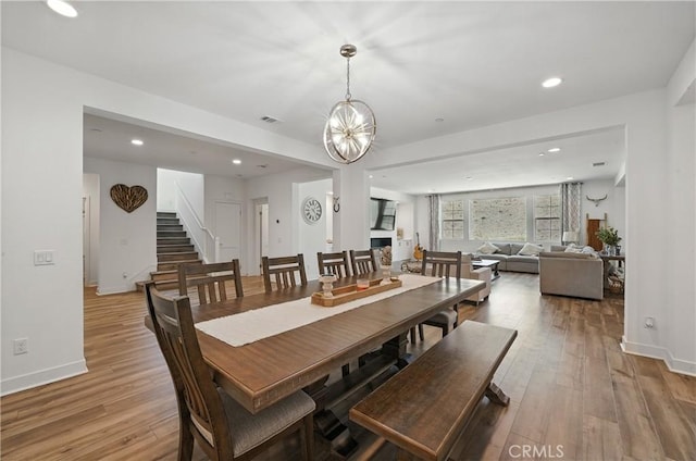 3969 Eliopulos Ranch Dr, Palmdale, CA 93551 - dining area featuring stairs, light wood-style floors, recessed lighting, and a chandelier