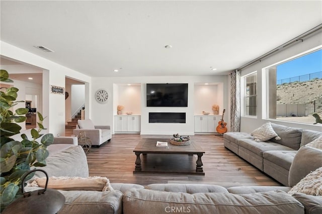 3969 Eliopulos Ranch Dr, Palmdale, CA 93551 - living room with wood finished floors, stairs, and recessed lighting