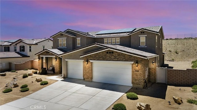 3969 Eliopulos Ranch Dr, Palmdale, CA 93551 - traditional home featuring driveway, solar panels, a garage, brick siding, and a tile roof