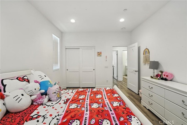 3969 Eliopulos Ranch Dr, Palmdale, CA 93551 - bedroom with light wood finished floors, a closet, and recessed lighting