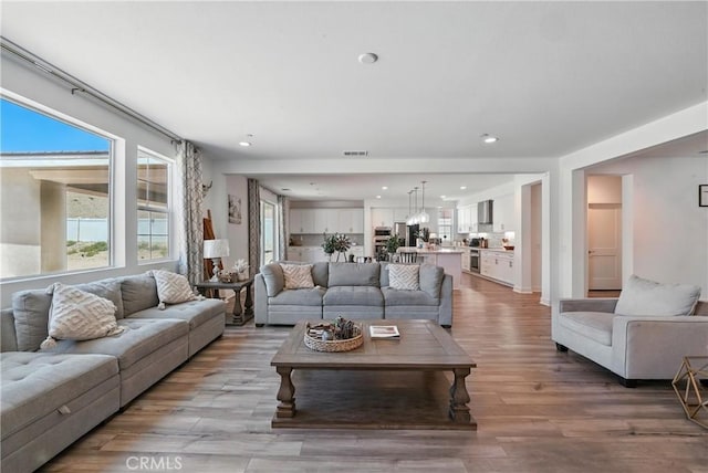 3969 Eliopulos Ranch Dr, Palmdale, CA 93551 - living room with light wood-style flooring and recessed lighting