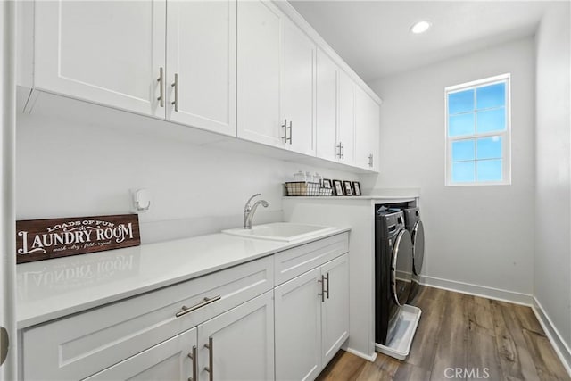 3969 Eliopulos Ranch Dr, Palmdale, CA 93551 - laundry room featuring independent washer and dryer, cabinet space, wood finished floors, and recessed lighting