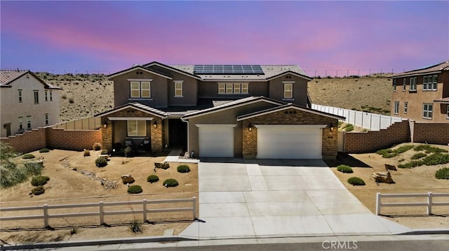 3969 Eliopulos Ranch Dr, Palmdale, CA 93551 - traditional-style house featuring roof mounted solar panels, driveway, brick siding, and stucco siding