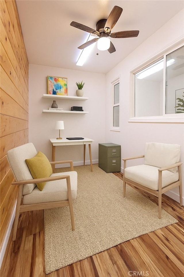 4215 Portola Ave, Los Angeles, CA 90032 - sitting room with ceiling fan, wood finished floors, and wooden walls