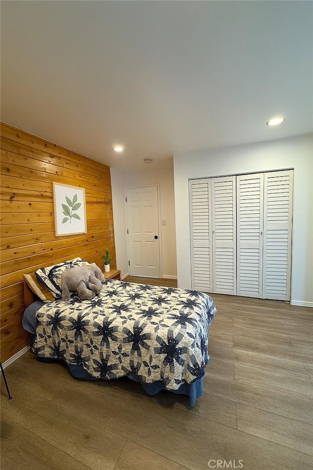 4215 Portola Ave, Los Angeles, CA 90032 - bedroom with recessed lighting, wooden walls, a closet, and wood finished floors