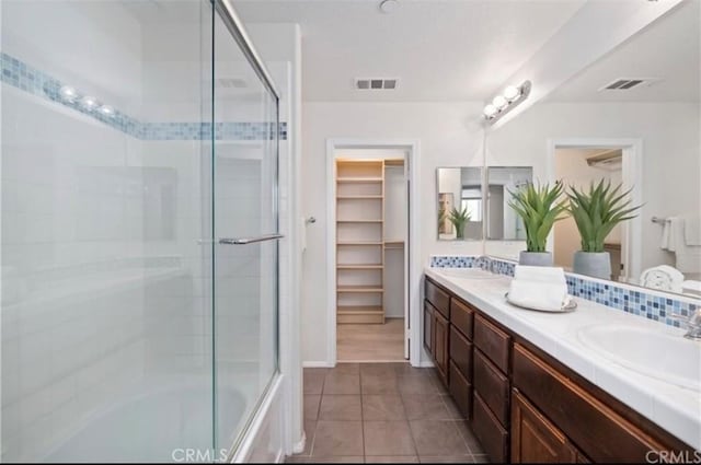 94 New Season, Irvine, CA 92602 - bathroom featuring double vanity, bath / shower combo with glass door, tile patterned flooring, and a walk in closet