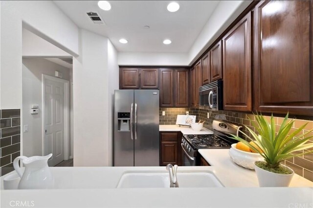 94 New Season, Irvine, CA 92602 - kitchen featuring stainless steel appliances, light countertops, recessed lighting, tasteful backsplash, and dark brown cabinets