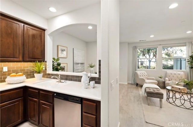 94 New Season, Irvine, CA 92602 - kitchen with stainless steel dishwasher, decorative backsplash, light wood-style flooring, recessed lighting, and light countertops
