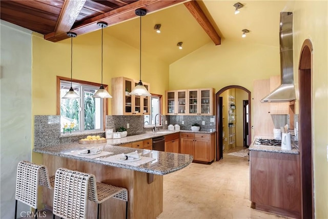 2 Chuckwagon Rd, Rolling Hills, CA 90274 - kitchen featuring arched walkways, wall chimney exhaust hood, a peninsula, beamed ceiling, and light stone counters