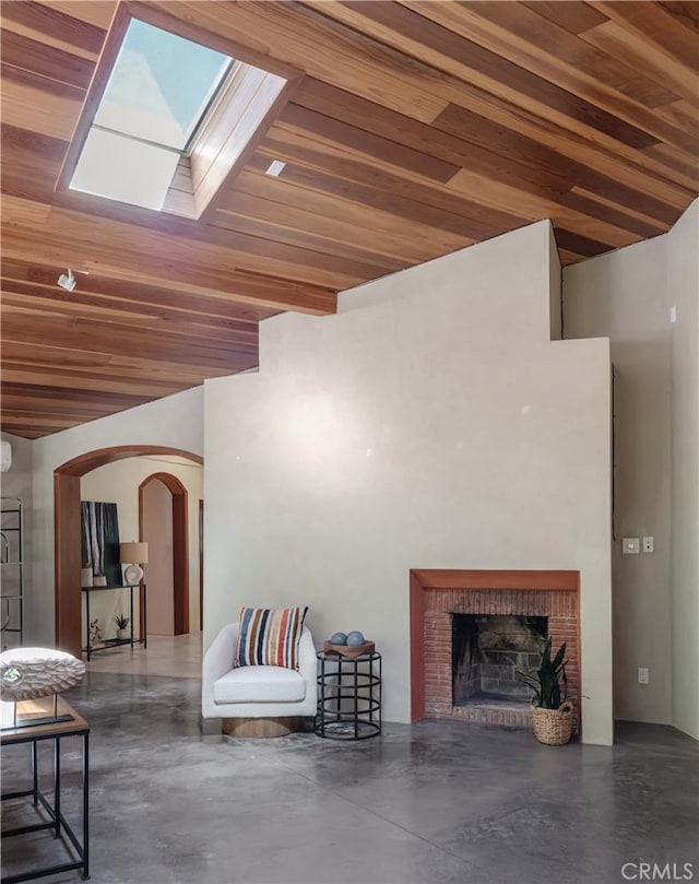 2 Chuckwagon Rd, Rolling Hills, CA 90274 - living room featuring concrete floors, arched walkways, wood ceiling, a skylight, and a fireplace