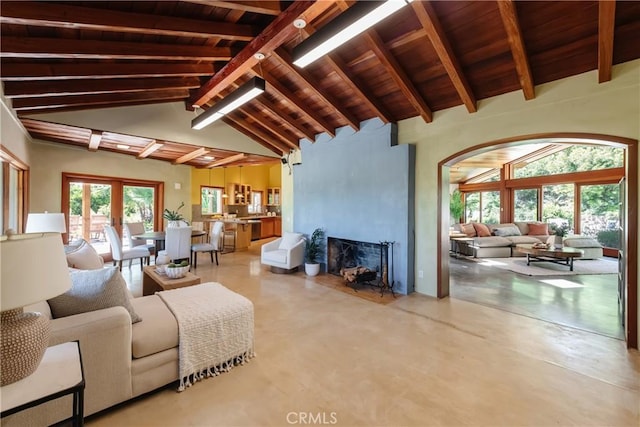 2 Chuckwagon Rd, Rolling Hills, CA 90274 - living room featuring a wood ceiling with exposed beams, a fireplace, high vaulted ceiling, and concrete flooring