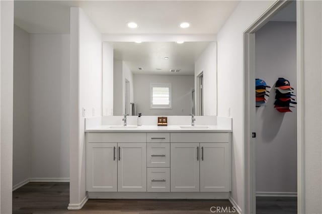157 Ambrosia Ct, Perris, CA 92571 - bathroom featuring double vanity, wood finished floors, and recessed lighting