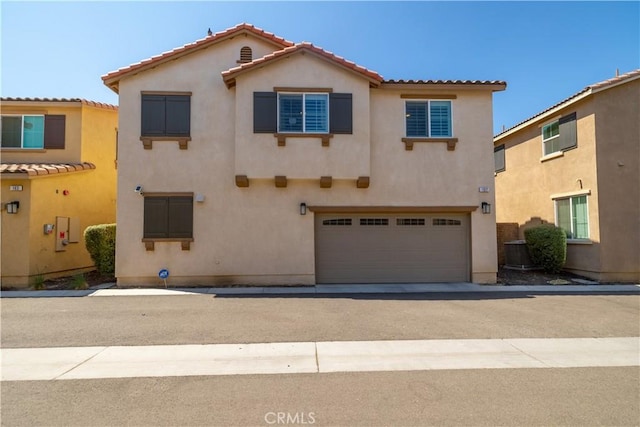 157 Ambrosia Ct, Perris, CA 92571 - mediterranean / spanish home with stucco siding, a tiled roof, an attached garage, and driveway