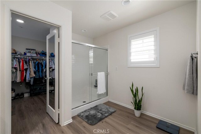 157 Ambrosia Ct, Perris, CA 92571 - full bath featuring wood finished floors, a stall shower, and a spacious closet