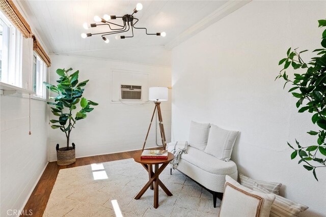 14348 Emelita St, Sherman Oaks, CA 91401 - sitting room with vaulted ceiling, wood finished floors, a chandelier, a wall mounted air conditioner, and crown molding