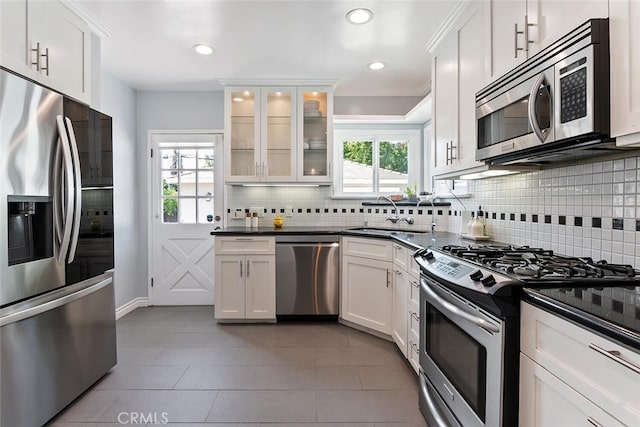 14348 Emelita St, Sherman Oaks, CA 91401 - kitchen with stainless steel appliances, backsplash, dark countertops, healthy amount of natural light, and recessed lighting