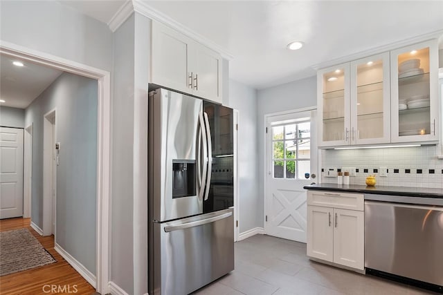 14348 Emelita St, Sherman Oaks, CA 91401 - kitchen with appliances with stainless steel finishes, backsplash, white cabinets, glass insert cabinets, and dark countertops
