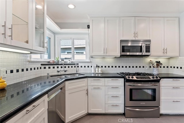 14348 Emelita St, Sherman Oaks, CA 91401 - kitchen featuring stainless steel appliances, crown molding, white cabinets, dark countertops, and tasteful backsplash