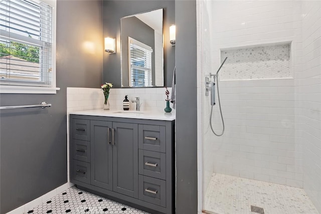 14348 Emelita St, Sherman Oaks, CA 91401 - bathroom featuring tiled shower, tile patterned flooring, vanity, and decorative backsplash