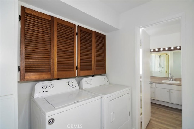 18931 Kittridge St Unit 73, Reseda, CA 91335 - laundry area with independent washer and dryer, cabinet space, and light wood-style flooring