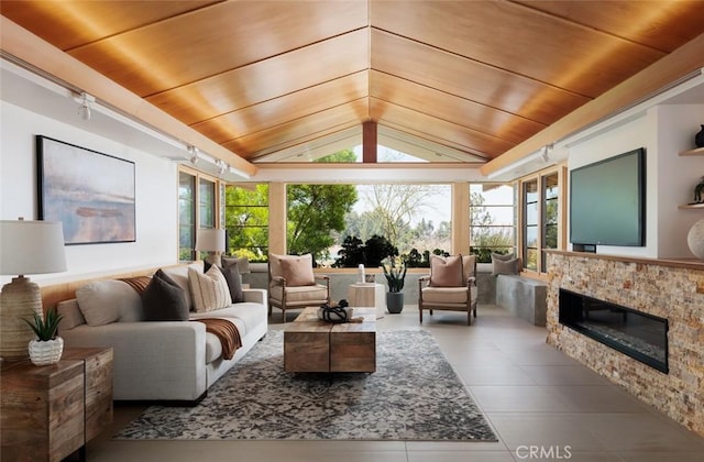 10551 Hillsboro Rd, North Tustin, CA 92705 - living room with wood ceiling, vaulted ceiling, tile patterned floors, and a glass covered fireplace