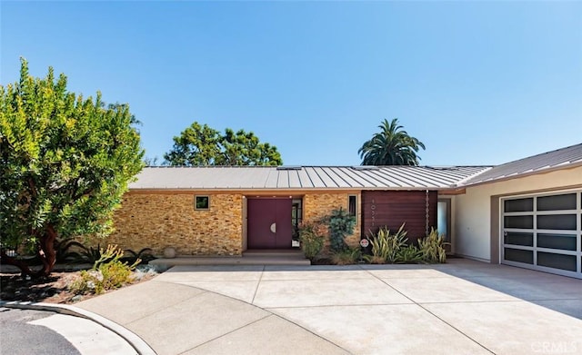 10551 Hillsboro Rd, North Tustin, CA 92705 - view of front of house featuring a garage, a metal roof, concrete driveway, and stucco siding