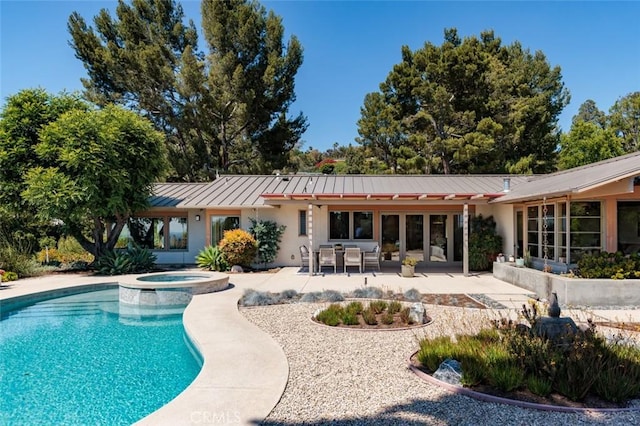 10551 Hillsboro Rd, North Tustin, CA 92705 - rear view of property with a standing seam roof, a patio, a metal roof, a pool with connected hot tub, and stucco siding