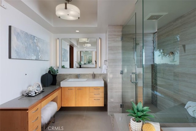 10551 Hillsboro Rd, North Tustin, CA 92705 - bathroom with a tray ceiling, tile patterned floors, vanity, a shower stall, and backsplash