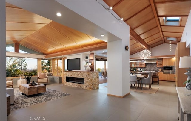 10551 Hillsboro Rd, North Tustin, CA 92705 - living area featuring wooden ceiling, lofted ceiling, and a glass covered fireplace