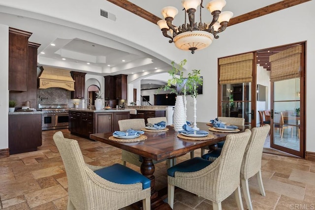 8183 Doug Hill, San Diego, CA 92127 - dining space with stone tile flooring, a chandelier, arched walkways, a tray ceiling, and recessed lighting