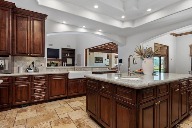 8183 Doug Hill, San Diego, CA 92127 - kitchen featuring arched walkways, recessed lighting, decorative backsplash, a tray ceiling, and light stone countertops