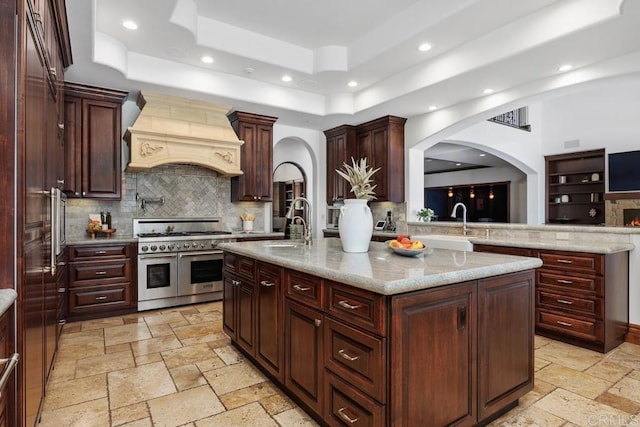 8183 Doug Hill, San Diego, CA 92127 - kitchen featuring double oven range, premium range hood, arched walkways, a raised ceiling, and recessed lighting