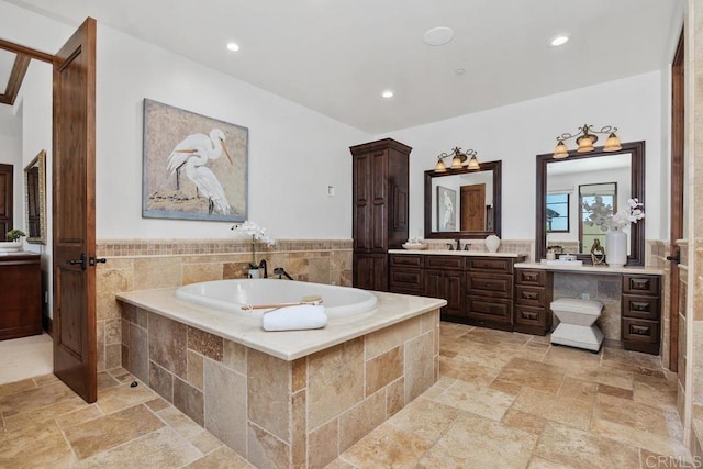 8183 Doug Hill, San Diego, CA 92127 - bathroom featuring a bath, vanity, stone tile flooring, recessed lighting, and tile walls