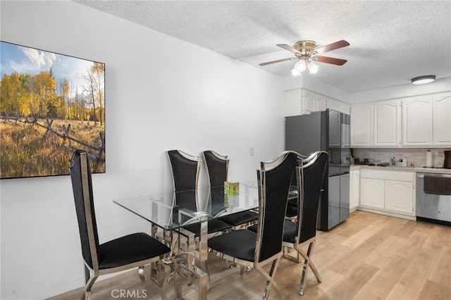 11025 Kittridge St Unit 128, North Hollywood, CA 91606 - dining room featuring a textured ceiling, light wood finished floors, and ceiling fan