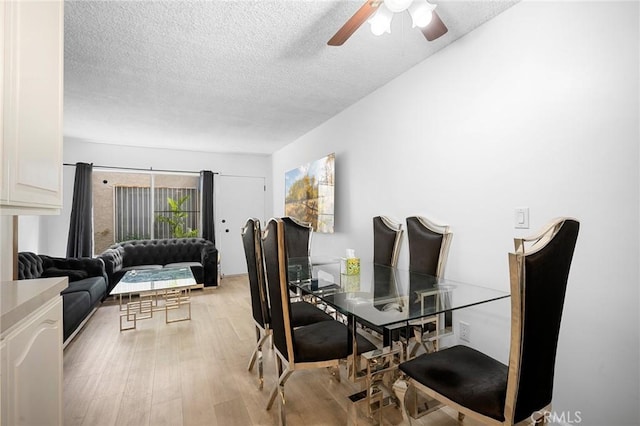 11025 Kittridge St Unit 128, North Hollywood, CA 91606 - dining room with a textured ceiling, a ceiling fan, and light wood-style floors