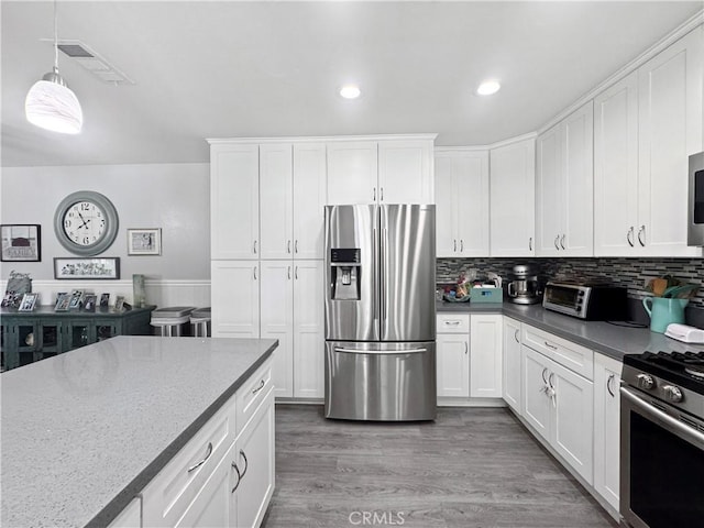 19891 Athenon Ave, Perris, CA 92570 - kitchen featuring stainless steel appliances, white cabinets, decorative light fixtures, recessed lighting, and wood finished floors