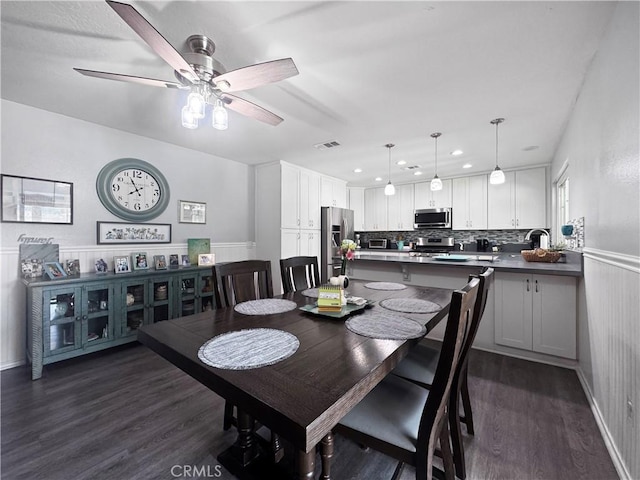 19891 Athenon Ave, Perris, CA 92570 - dining space with dark wood-type flooring, a wainscoted wall, ceiling fan, and recessed lighting