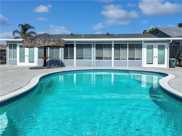 19891 Athenon Ave, Perris, CA 92570 - rear view of property featuring french doors, a patio area, and an outdoor pool